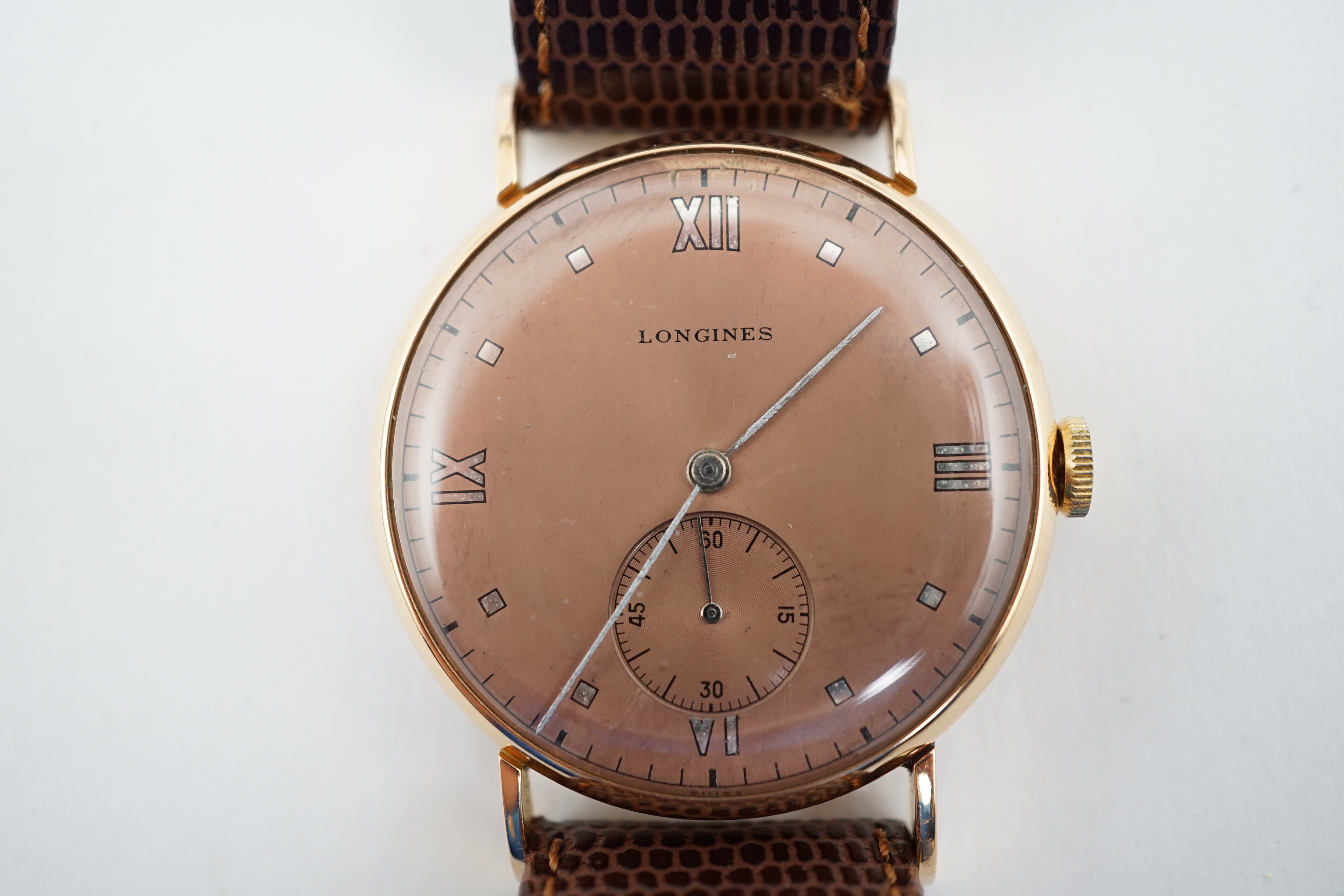 A gentleman's 1950's 18k pink gold Longines manual wind wrist watch